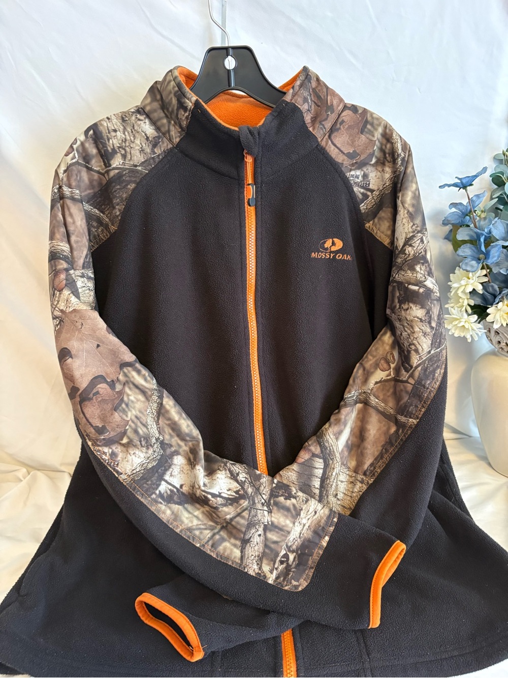 Mossy Oak Men’s Black Fleece Jacket with Camo Sleeves and Orange Trim